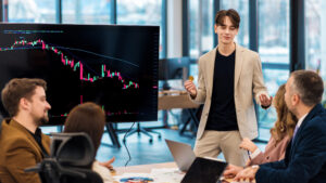 young worker leading business meeting about cryptocurrencies in an office