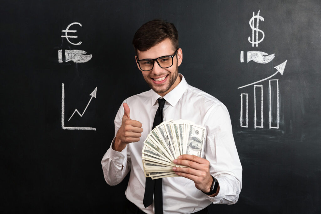 close up portrait of young smiling businessman holding bunch of